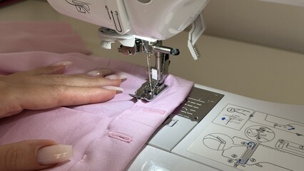  Close-up of Sewing Machine Presser Foot and Hands Sewing Pink Fabric