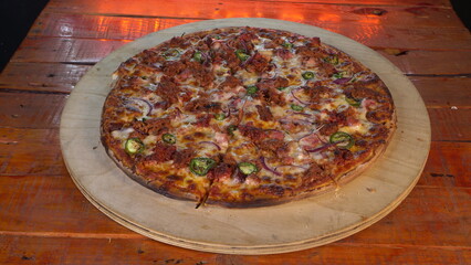 Mexican pizza on a wooden table