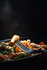 stir-fried dish of chicken, pumpkin, pepper, onion, parsley, garlic, carrot and various vegetables