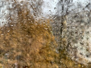 raindrops on the glass, on the blurred background of the window view