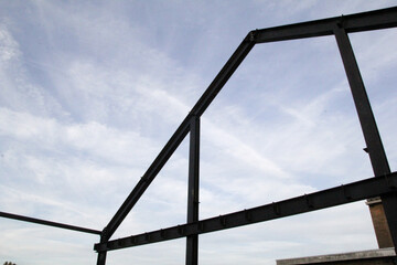 the steel construction of the side wall of a shed closeup in the countryside and the sky