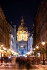Fototapeta premium Christmas Advent fair with colorful lights in the square in front of the Saint Stephen's Basilica in Budapest