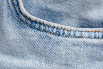 Close-up of a pocket of light jeans with seam details