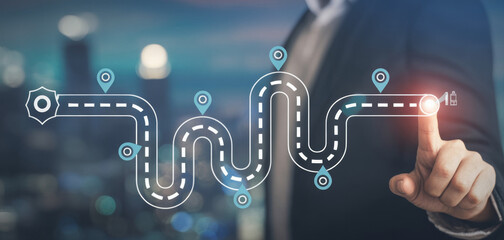 Businessman pointing at a digital roadmap with location pins illustrating business strategy and navigation on a blurred background