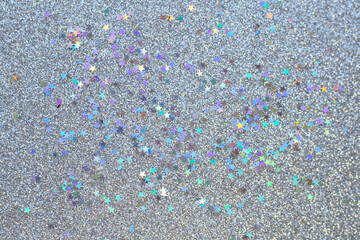 Sparkling glitter background with colorful star confetti and festive shimmer texture