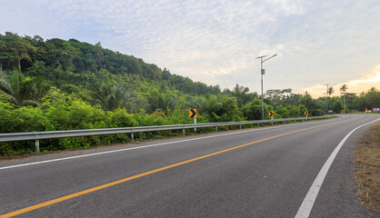 Fototapeta premium Road with a yellow line down the middle and a few trees in the background