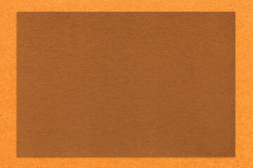 Textured brown paper background with orange border. Vintage kraft cardboard with empty frame. Banner with copy space