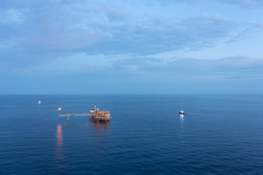 Central processing platform (cpp) in the middle of the ocean during sunset time - upstream industry