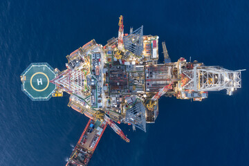 Aerial view of offshore jack up rig and offshore platform during sunset for oil and gas exploration...