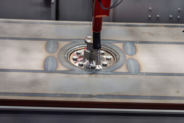 Robot welds steel. Welding head. Weld robot. CNC welding. Robotization and automation of the weld process. Robot welding steel. Industrial welding robot and working with metal parts