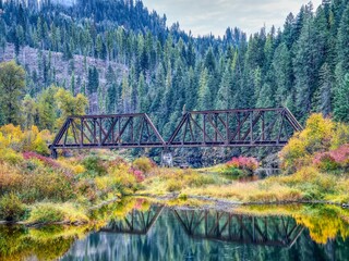  Bridge over calm river in autumn.