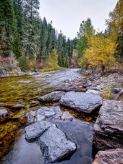   Large rocks in the stream in autumn.