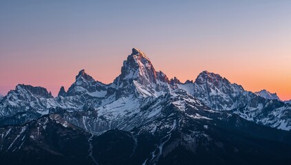Majestic Mountain Range at Dawn. A Symphony of Light, Snow, and Jagged Peaks.