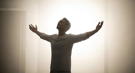 Man, arms outstretched, bathed in bright light, symbol of liberation and peace