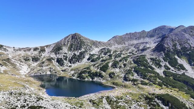 Bucura Lake camping and Retezat Mountains aerial view in Romania