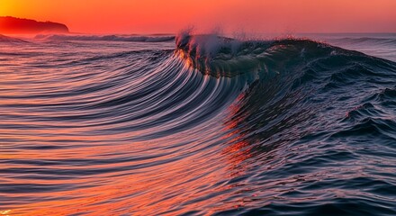 Dramatic ocean wave cresting under a vibrant, fiery red and orange sunrise
