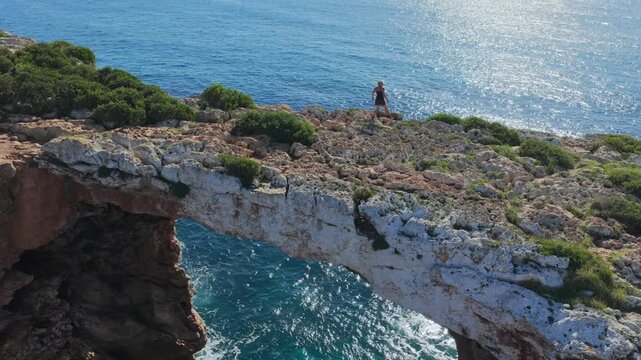 Aerial view of Cala Varques suspended rock arch above the mediterranean sea in mallorca