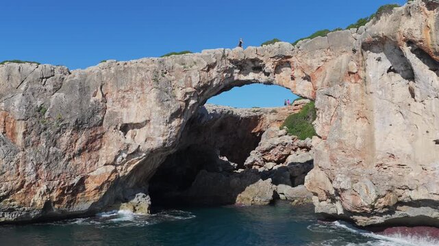 Aerial view of Cala Varques suspended rock arch above the mediterranean sea in mallorca