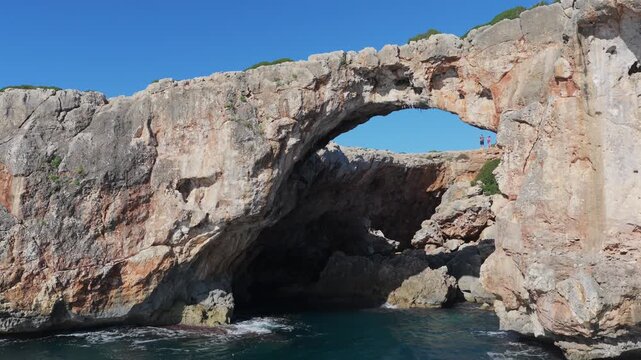 Aerial View: Cala Varques' Iconic Suspended Rock Arch Over the Mediterranean Sea, Mallorca