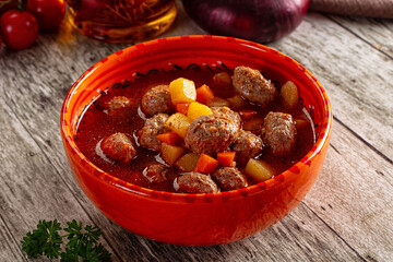 Tomato soup with meatballs and vegetables