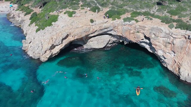 Aerial View Crystal Clear Turquoise Waters, Sea Caves, and Natural Arch of Cala Varques, Mallorca