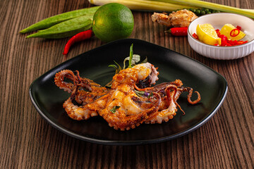 Gourmet grilled whole octopus served lime