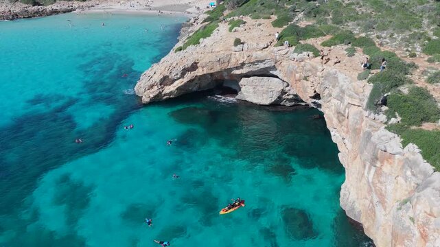 Aerial View Crystal Clear Turquoise Waters, Sea Caves, and Natural Arch of Cala Varques, Mallorca