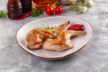 Roasted rabbit leg served rosemary