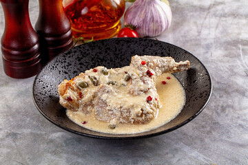 Roasted rabbit legs in cream sauce