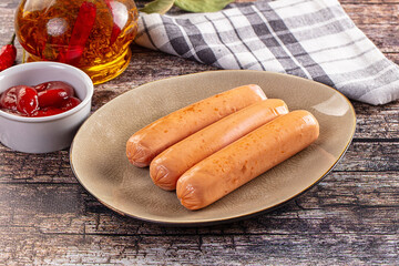 Boiled sausages with ketchup