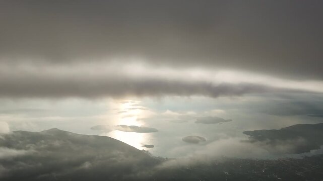An aerial pan clip of Nidri village and islands through a break in the clouds. Lefkada island, Greece.
