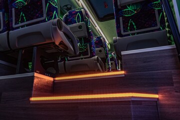 Luxurious bus interior with green leather seats and starlight ceiling. Elegant lighting and modern design create a premium, comfortable, and exclusive atmosphere for luxury travel or VIP transport.
