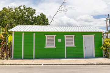 Pedernales, Dominican Republic, 8 august 2025. Typical Dominican Caribbean house made of wood, painted a bright green color.