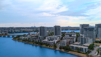 Obraz premium Aerial Drone View of Wentworth Point and Rhodes a suburb in western Sydney newly built residential high rise apartments area on Parramatta River Sydney NSW Australia
