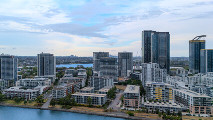 Naklejka premium Aerial Drone View of Wentworth Point and Rhodes a suburb in western Sydney newly built residential high rise apartments area on Parramatta River Sydney NSW Australia