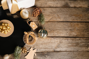 Vinyl disc with Christmas decorations, gift box and fir branches on wooden background
