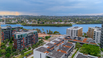 Obraz premium Aerial Drone View of Wentworth Point and Rhodes a suburb in western Sydney newly built residential high rise apartments area on Parramatta River Sydney NSW Australia