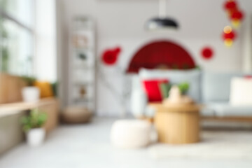 Blurred view of light living room with sofa, table and decor for Japanese New Year celebration