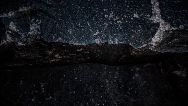 Abstract dark textured rock surface with natural patterns