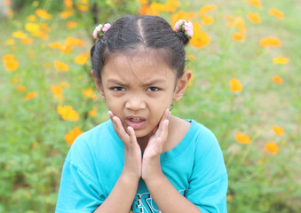Fototapeta premium A young Asian girl is in a beautiful outdoor cosmos flower garden.
