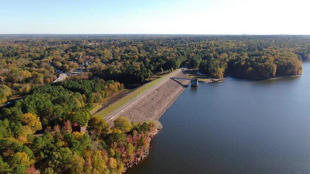 Aerial Drone View of Falls Lake Dam and Earthen Embankment with Autumn Foliage in Raleigh, North Carolina: Engineering, Industry, Infrastructure, Technology