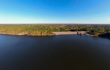 Aerial Drone View of Falls Lake Dam and Earthen Embankment with Autumn Foliage in Raleigh, North Carolina: Engineering, Industry, Infrastructure, Technology