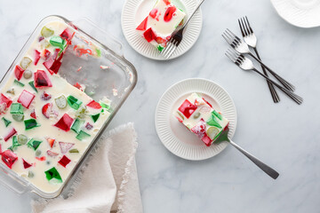 Servings from a glass dish of homemade fruity gelatin dessert. 