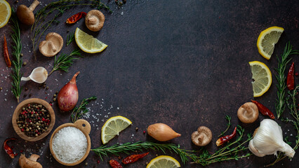 A selection of ingredients used to flavour a meal, against a dark background.