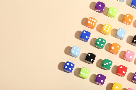 Colorful game dices on beige background