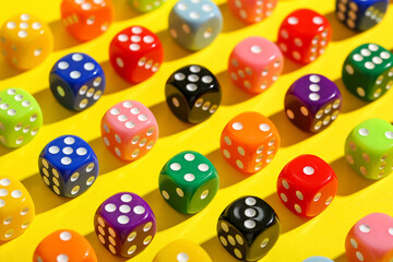 Colorful game dices on yellow background