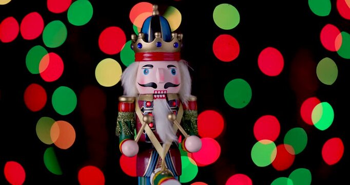 Nutcracker Wooden Soldier Toy against bokeh of festive vintage backdrop Christmas lights video