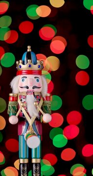 Nutcracker Wooden Soldier Toy against bokeh of festive vintage backdrop Christmas lights video
