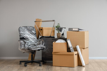Wrapped furniture with stretch film and moving boxes in office