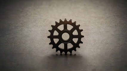 Isolated metallic gear wheel on a dark, textured background, symbolizing the intricate mechanics of systems, precision engineering, and the essential components driving progress and innovation